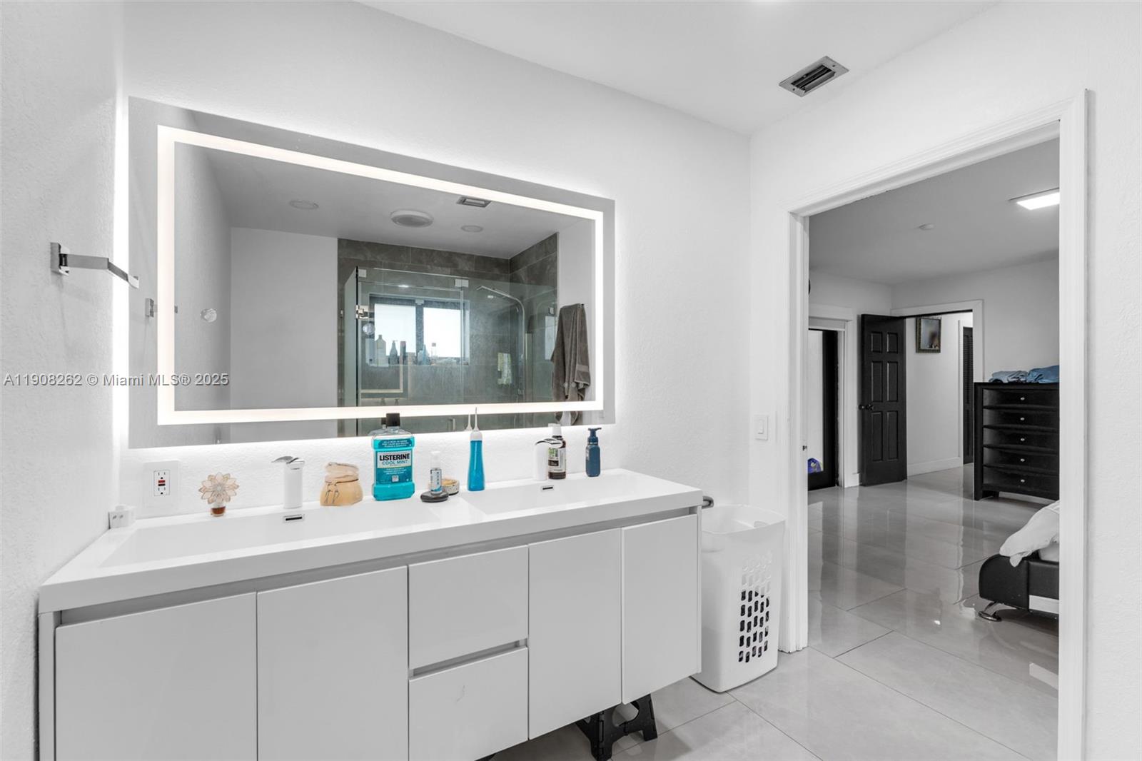 551 Southwest 127th Avenue Miami, FL 33184 - Photo 25 of 47 a bathroom with double vanity sink and a mirror