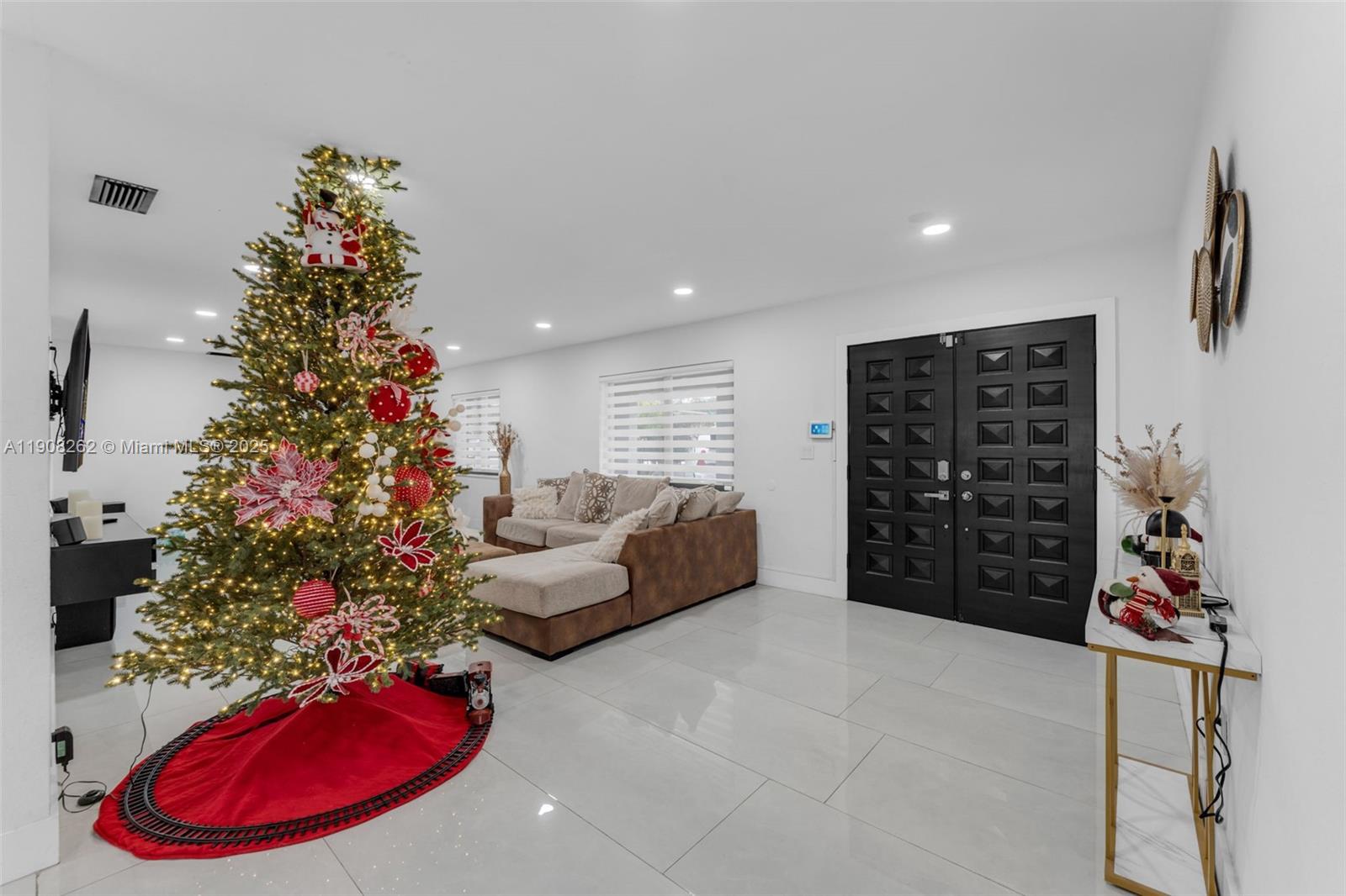 551 Southwest 127th Avenue Miami, FL 33184 - Photo 4 of 47 a living room with furniture a flowers and a bookshelf