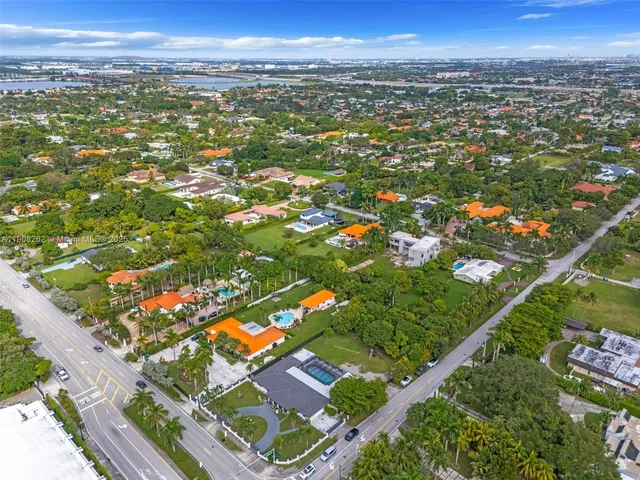 an aerial view of residential houses and car parked
