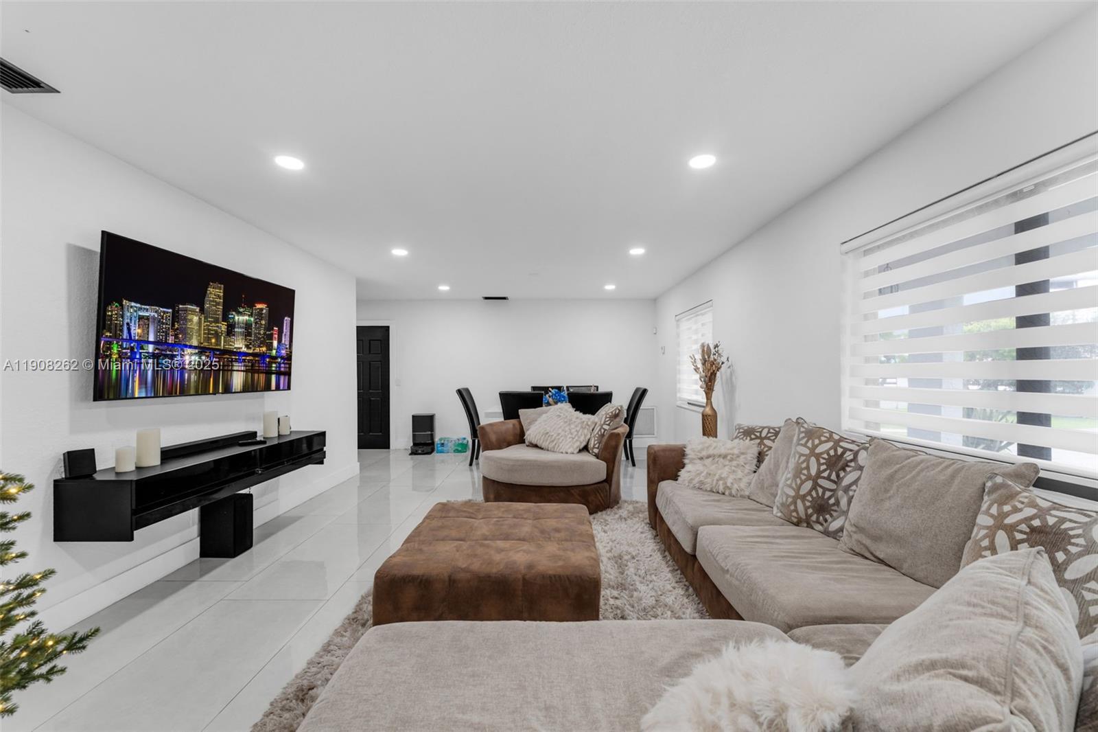 551 Southwest 127th Avenue Miami, FL 33184 - Photo 5 of 47 a living room with furniture and a flat screen tv