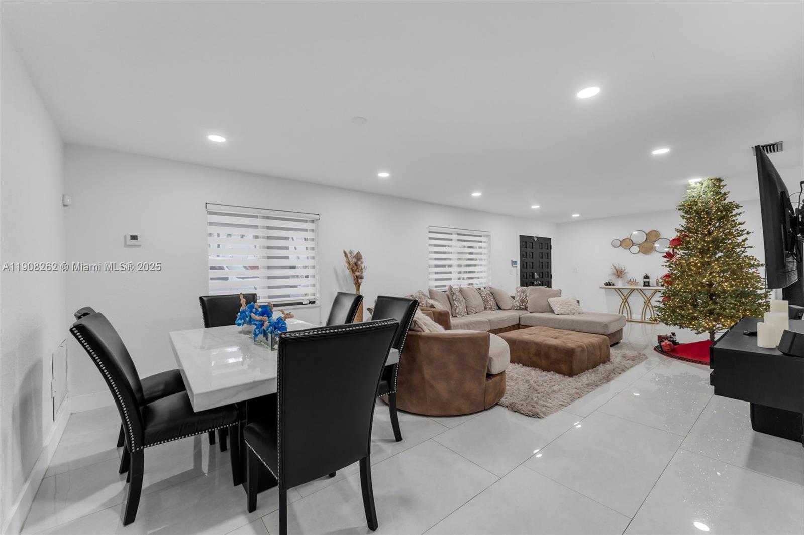 551 Southwest 127th Avenue Miami, FL 33184 - Photo 6 of 47 a dining room with furniture a potted plant and a window