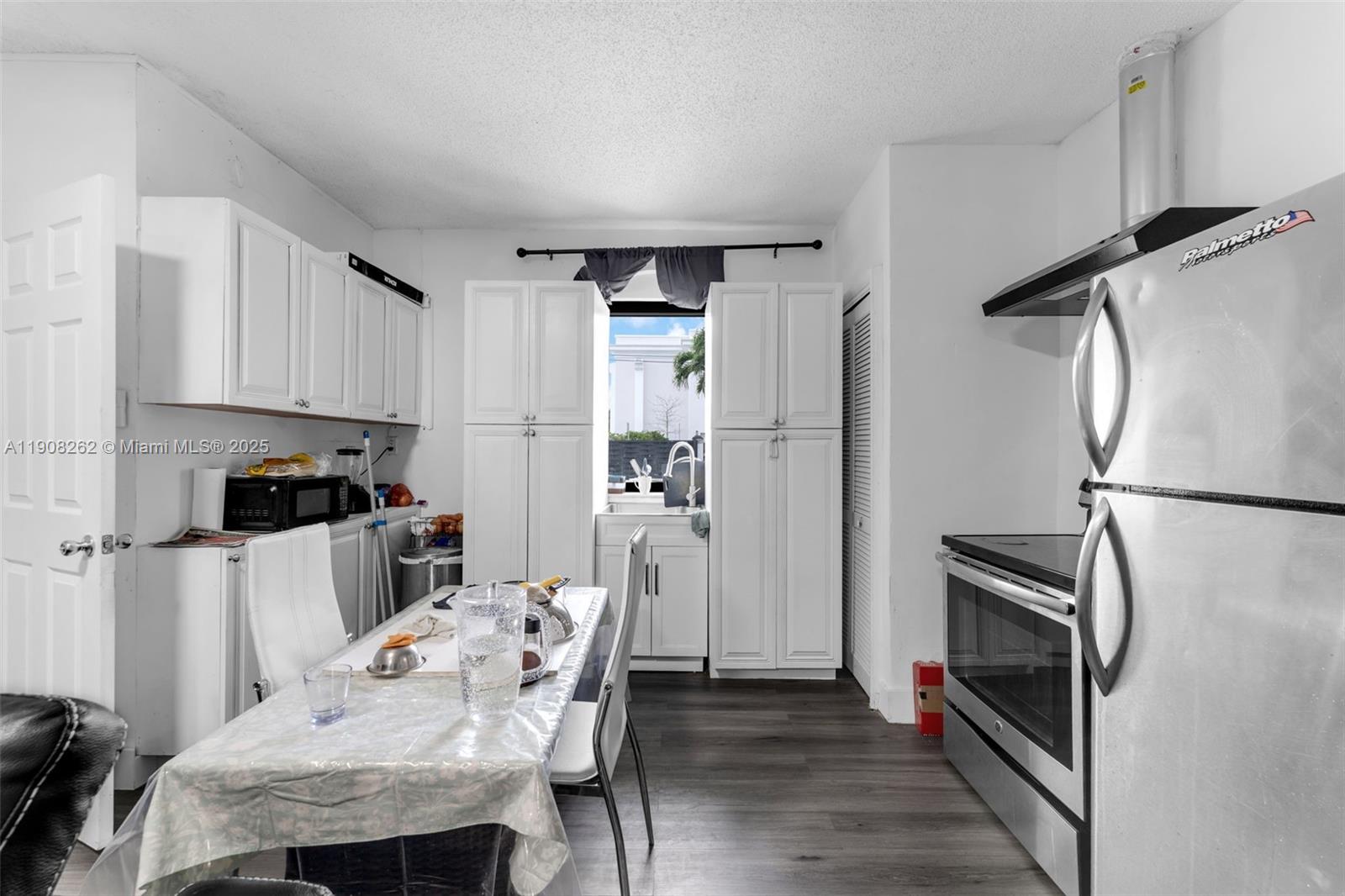 551 Southwest 127th Avenue Miami, FL 33184 - Photo 9 of 47 a kitchen with a refrigerator and a stove top oven
