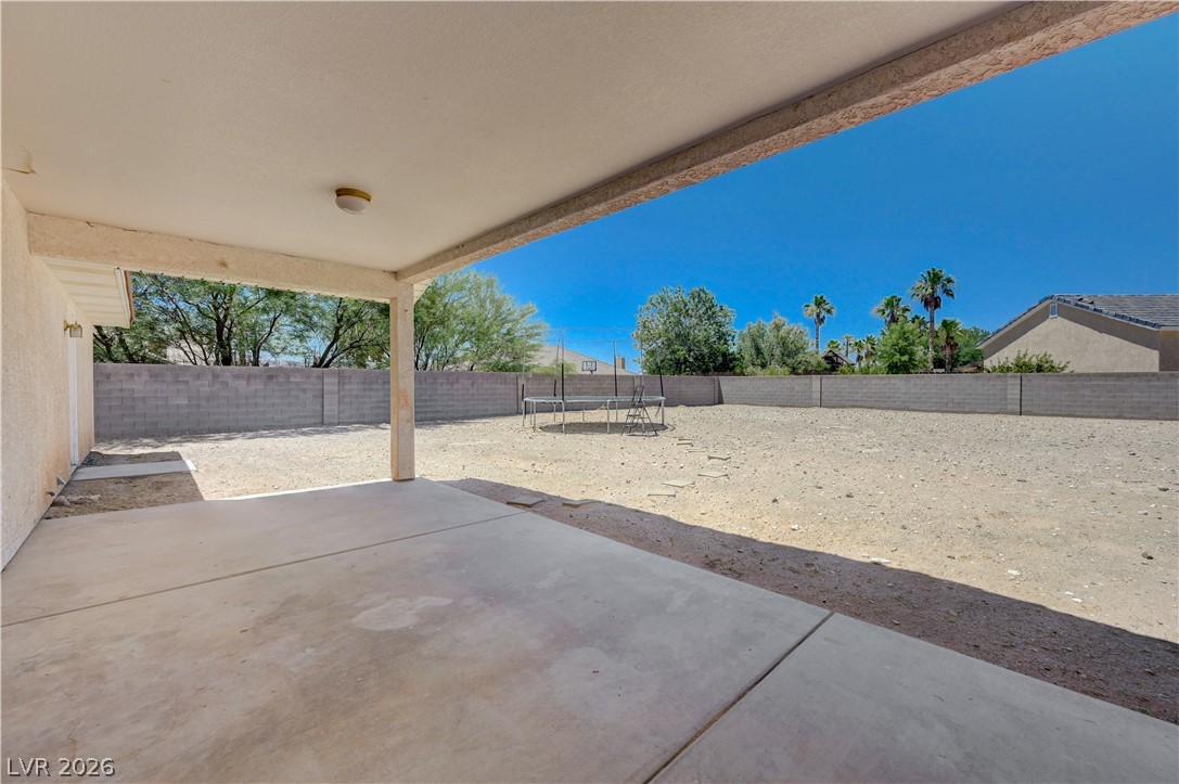 1272 Liston Avenue Logandale, NV 89021 - Photo 43 of 61 A spacious covered patio offers a refreshing retreat, opening to a private backyard oasis.