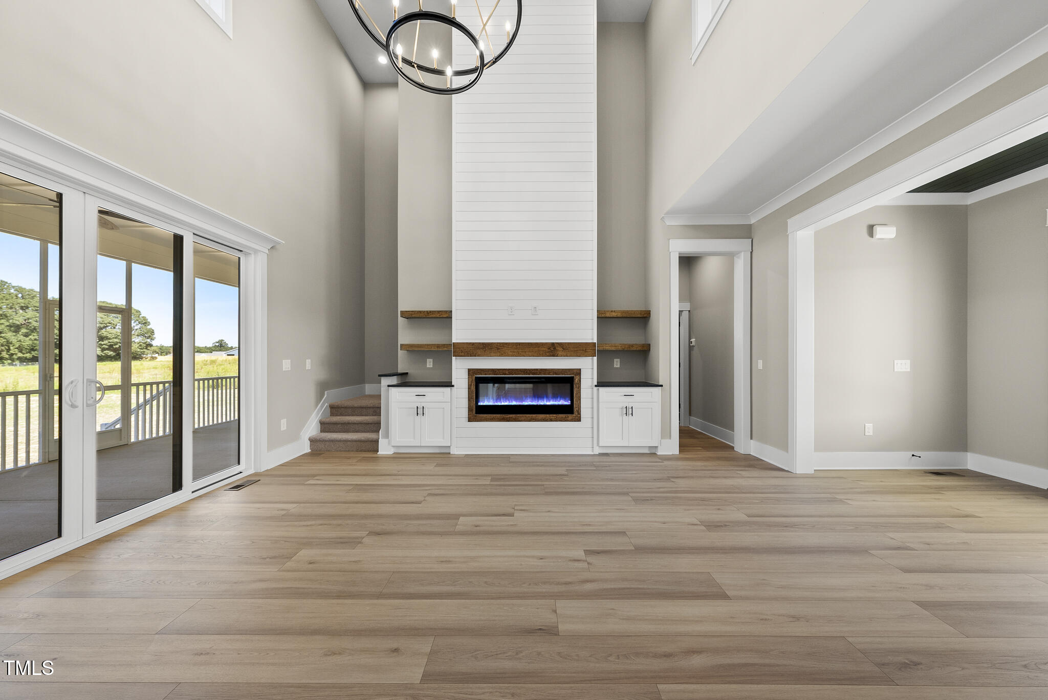 2560 Lassiter Road Four Oaks, NC 27524 - Photo 11 of 66 a view of an empty room with wooden floor and a window