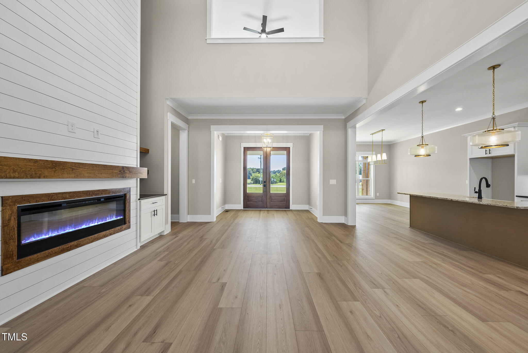 2560 Lassiter Road Four Oaks, NC 27524 - Photo 12 of 66 a view of kitchen living room with wooden floor and fireplace