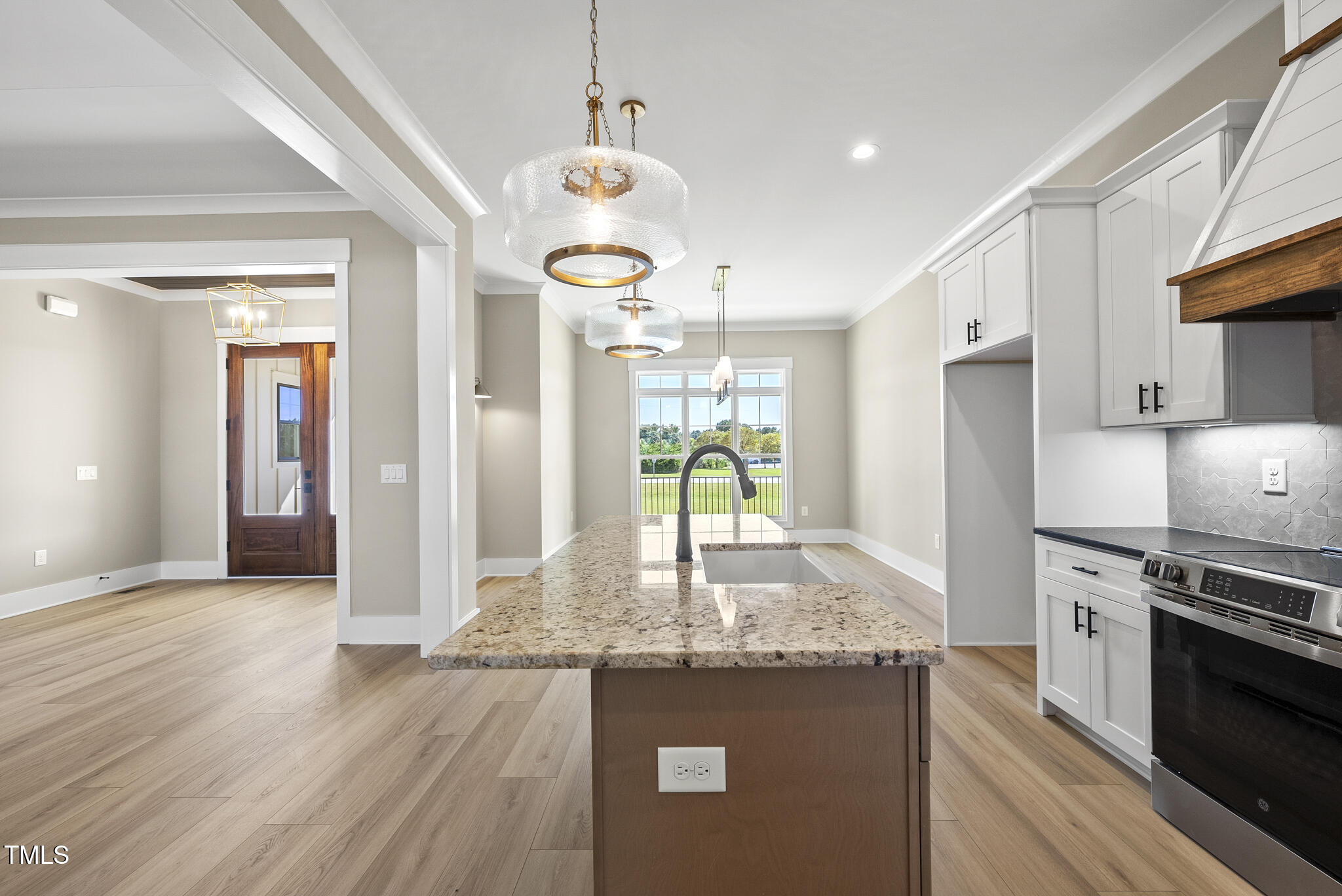 2560 Lassiter Road Four Oaks, NC 27524 - Photo 18 of 66 a kitchen with granite countertop kitchen island stainless steel appliances a stove cabinets and wooden floor