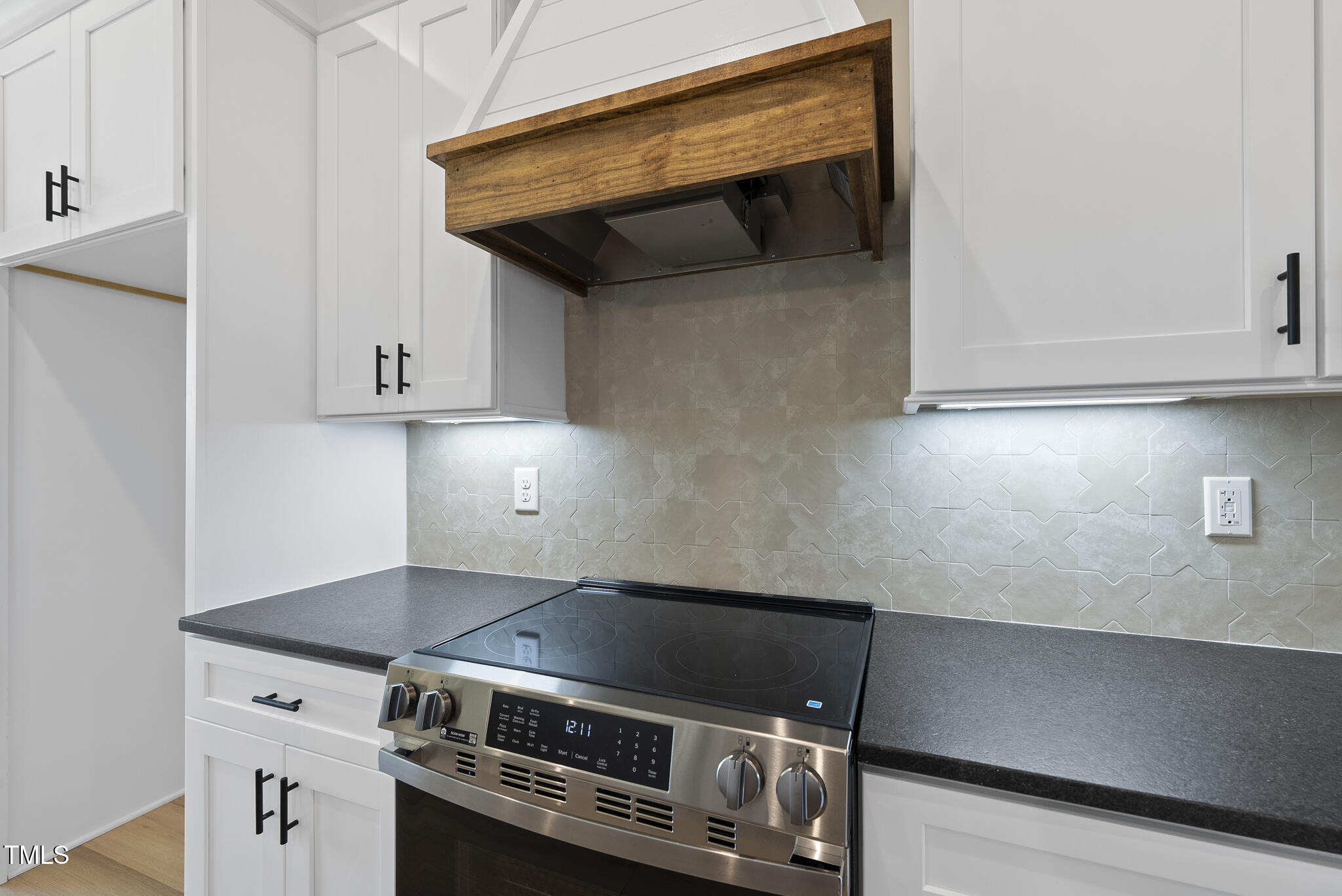2560 Lassiter Road Four Oaks, NC 27524 - Photo 19 of 66 a stove top oven sitting inside of a kitchen