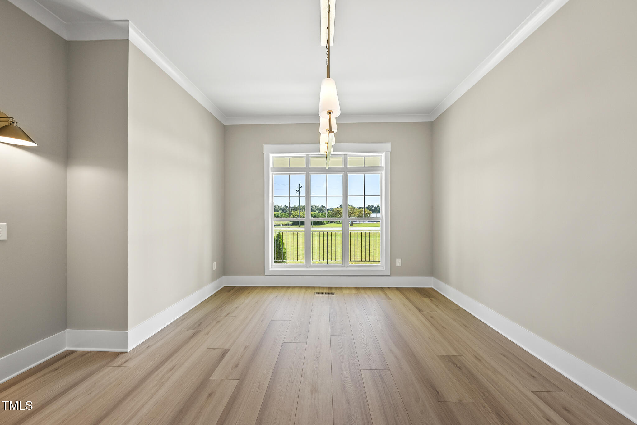 2560 Lassiter Road Four Oaks, NC 27524 - Photo 20 of 66 a view of an empty room with wooden floor and a window