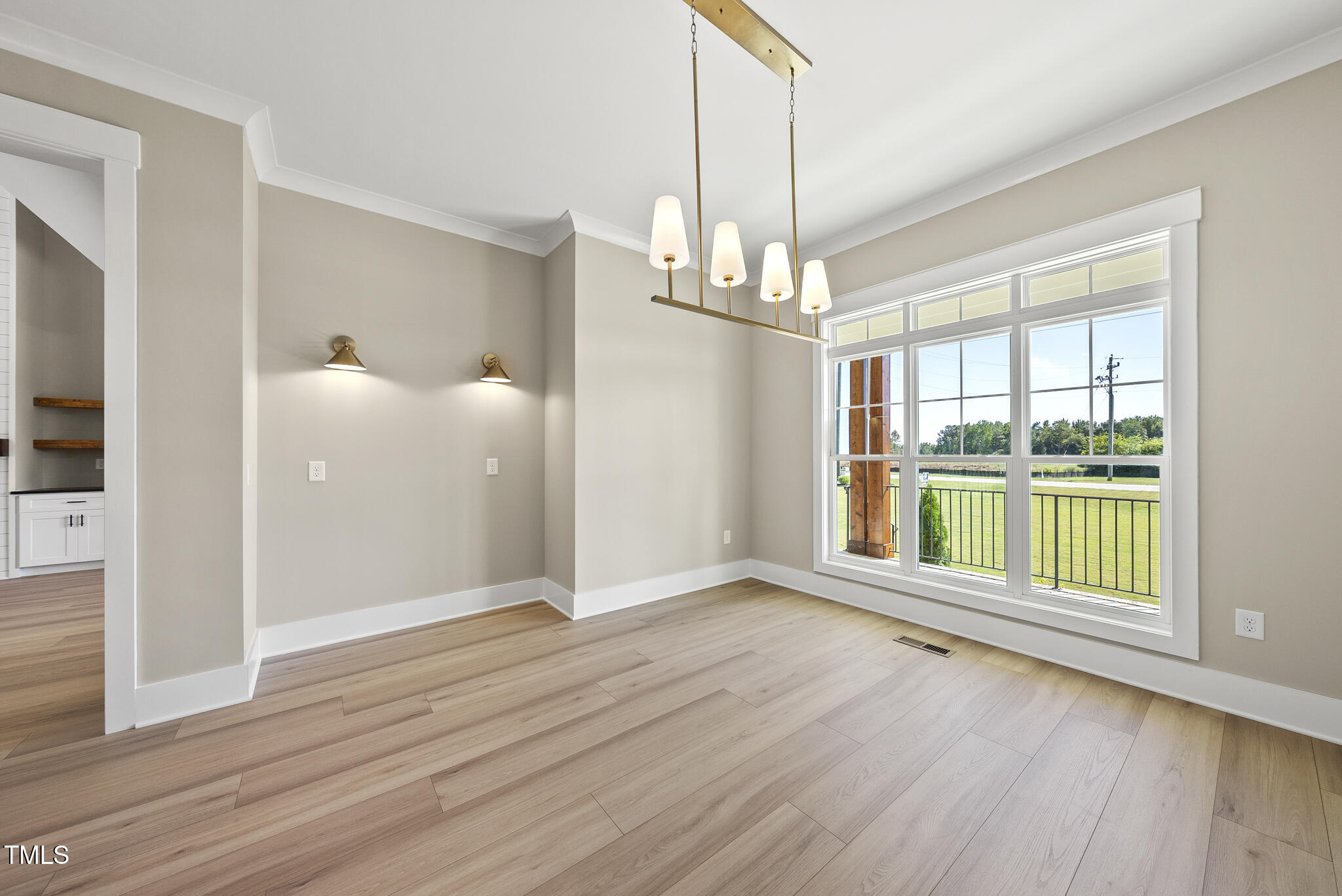 2560 Lassiter Road Four Oaks, NC 27524 - Photo 22 of 66 a view of an empty room with wooden floor and a window