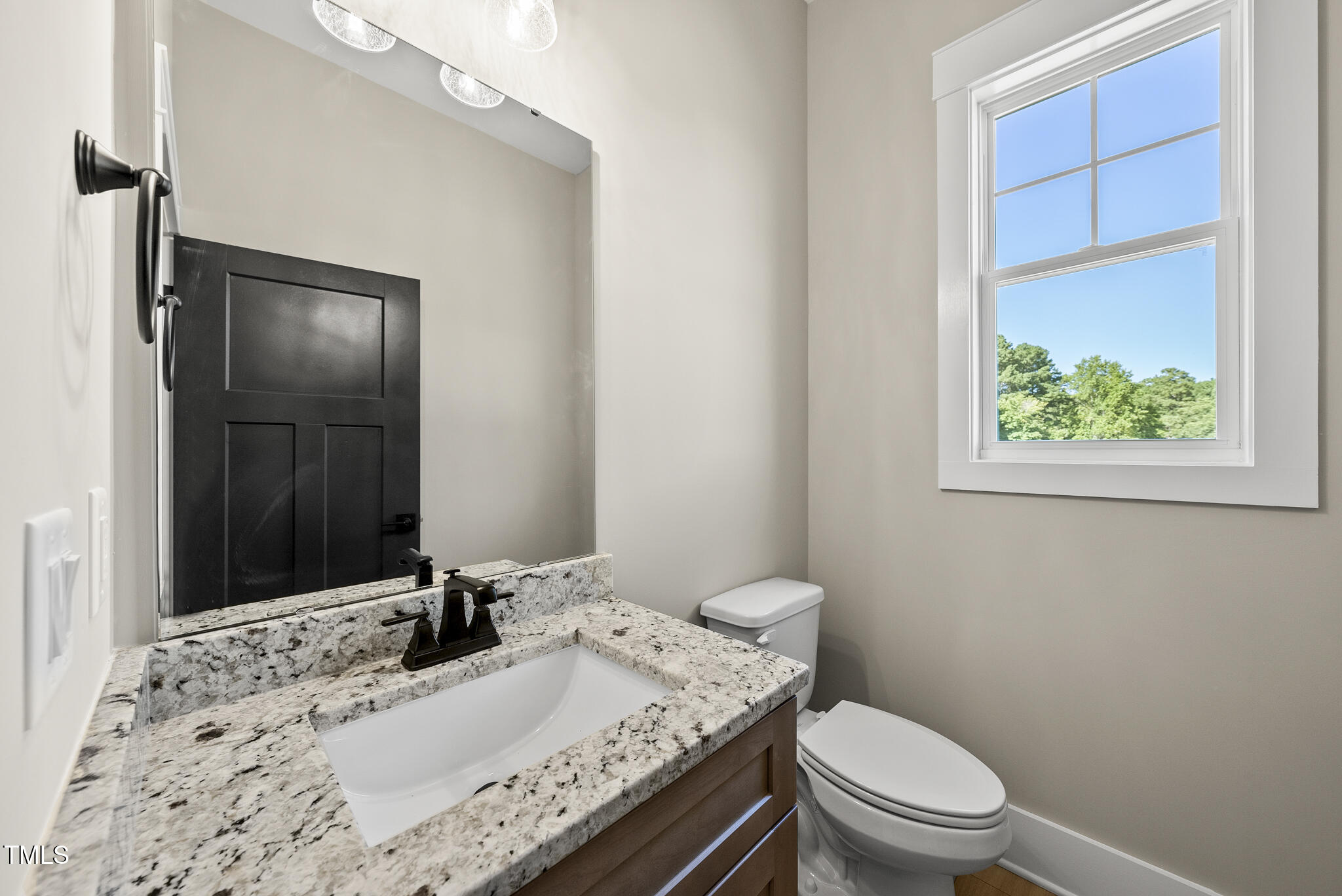 2560 Lassiter Road Four Oaks, NC 27524 - Photo 27 of 66 a bathroom with a granite countertop sink a toilet and shower