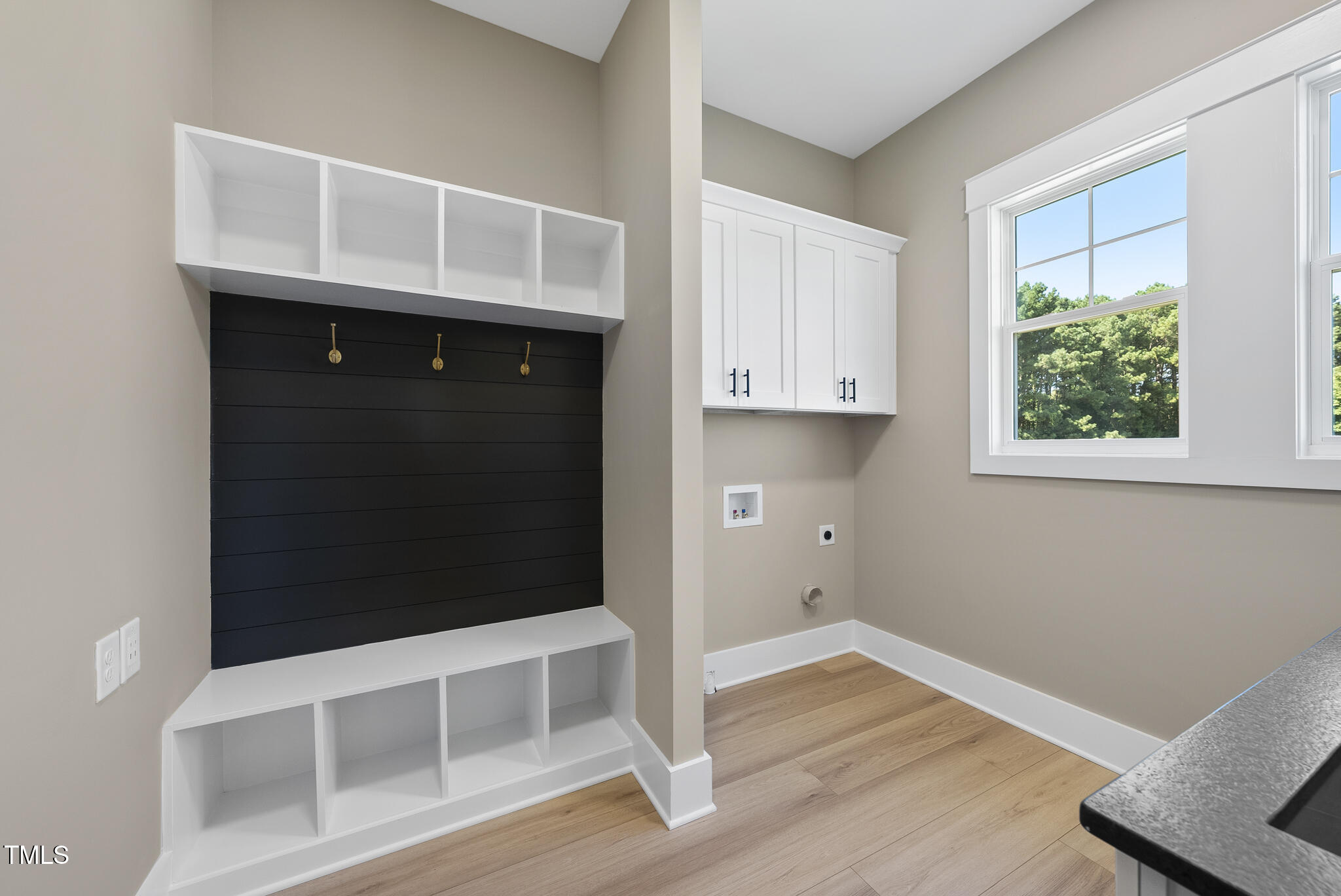 2560 Lassiter Road Four Oaks, NC 27524 - Photo 29 of 66 a room with a wooden floor and cabinets