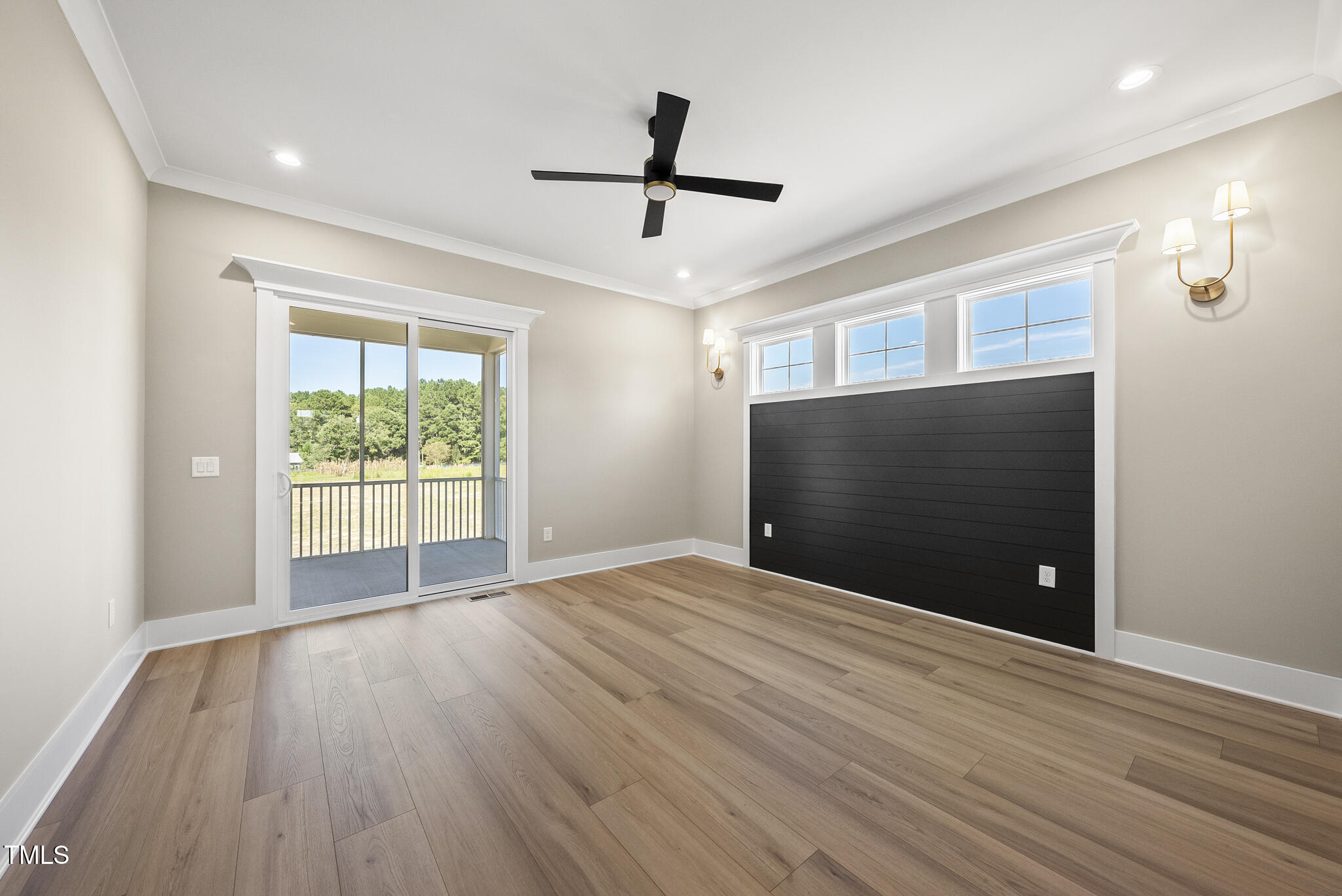 2560 Lassiter Road Four Oaks, NC 27524 - Photo 33 of 66 a view of an empty room with wooden floor and a window