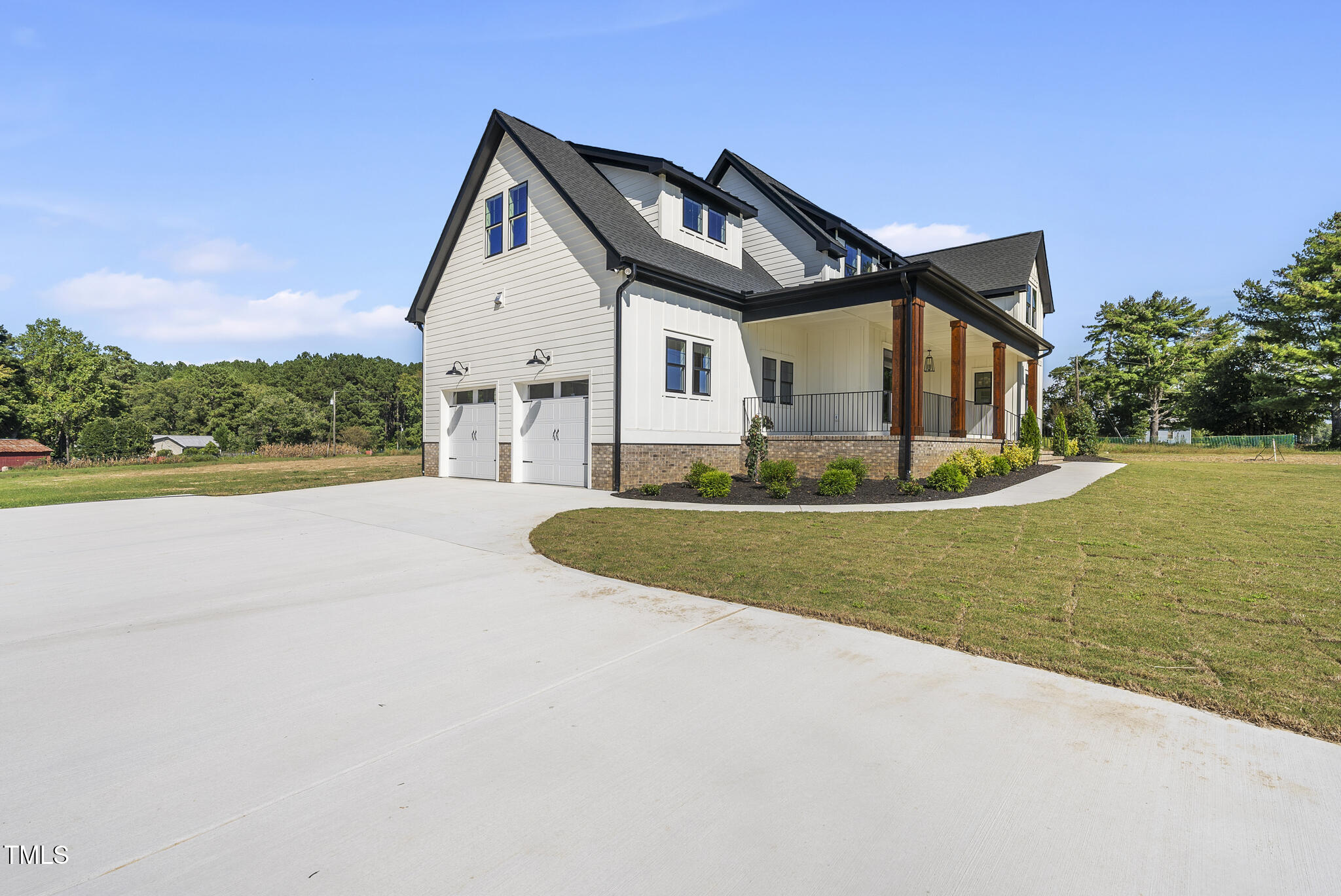 2560 Lassiter Road Four Oaks, NC 27524 - Photo 4 of 66 a front view of a house with a yard and garage