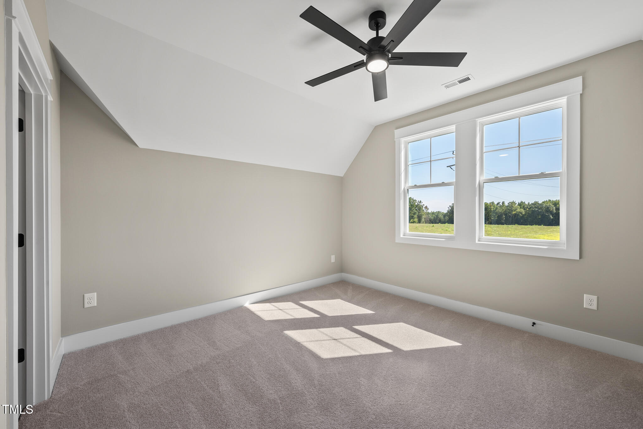 2560 Lassiter Road Four Oaks, NC 27524 - Photo 44 of 66 an empty room with a window and a fan