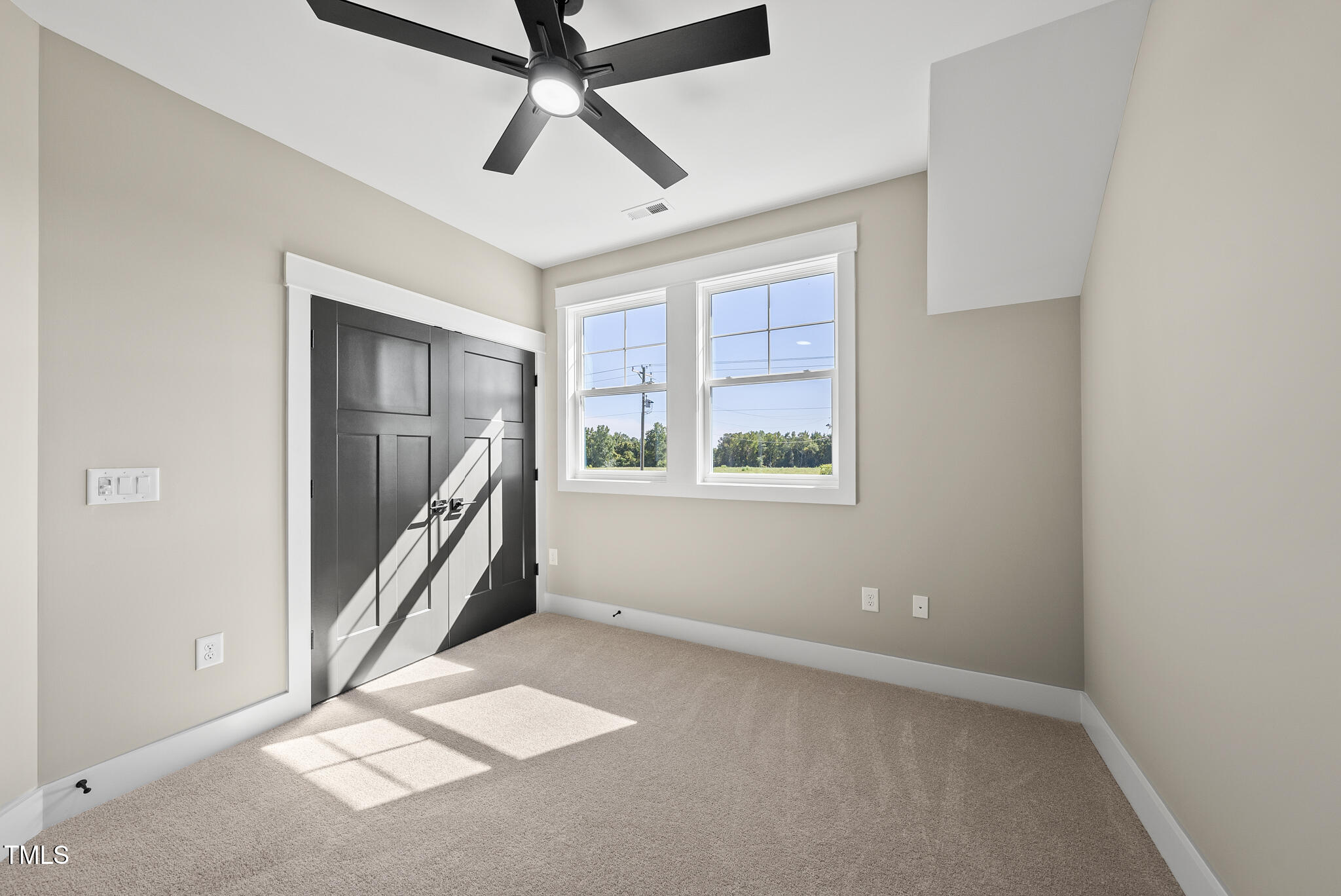 2560 Lassiter Road Four Oaks, NC 27524 - Photo 54 of 66 an empty room with windows and fan