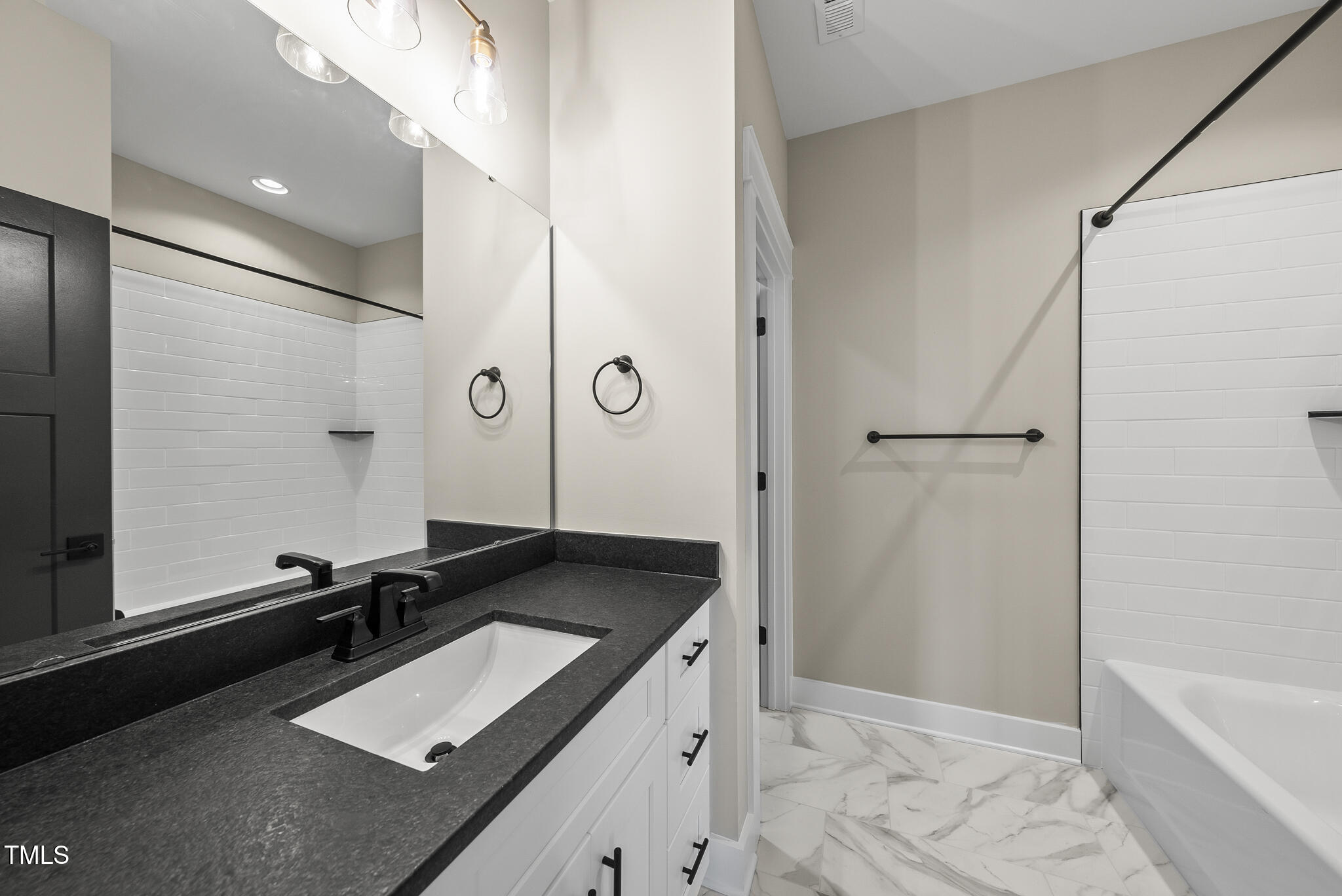 2560 Lassiter Road Four Oaks, NC 27524 - Photo 55 of 66 a room with a refrigerator and a sink