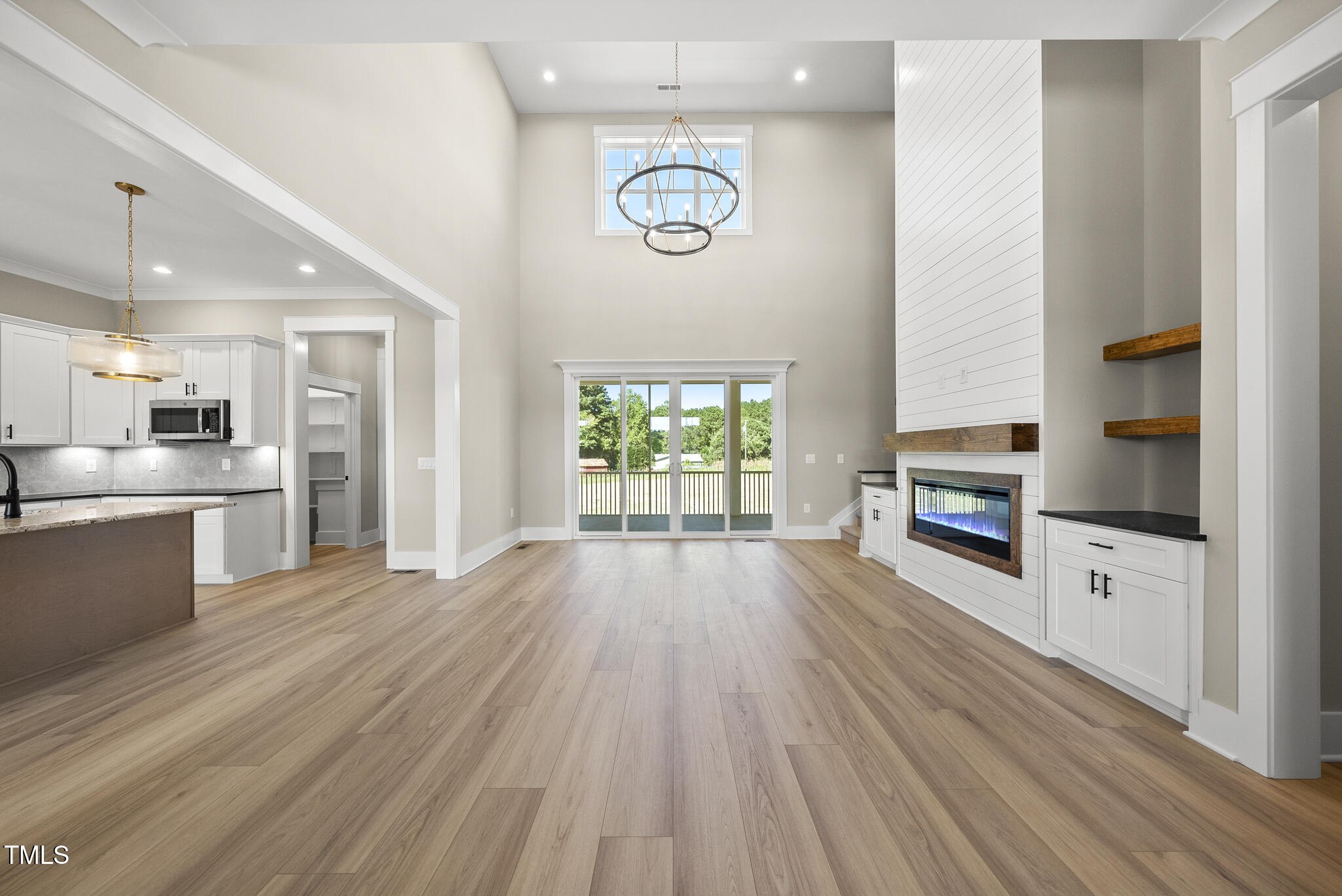 2560 Lassiter Road Four Oaks, NC 27524 - Photo 9 of 66 a open kitchen with white cabinets and stainless steel appliances