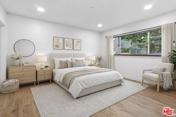 a bedroom with a bed and a large window