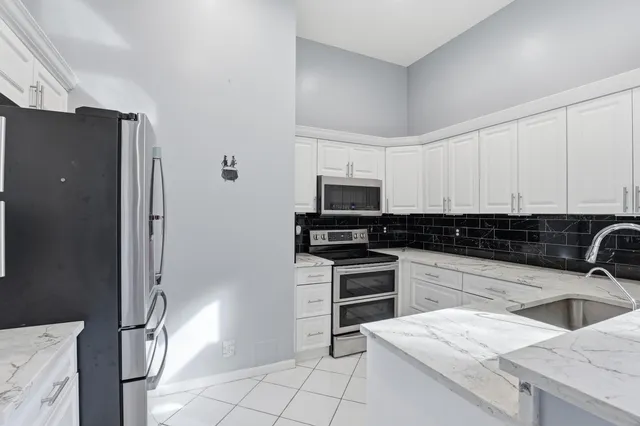 a bedroom with a bed and a potted plant
