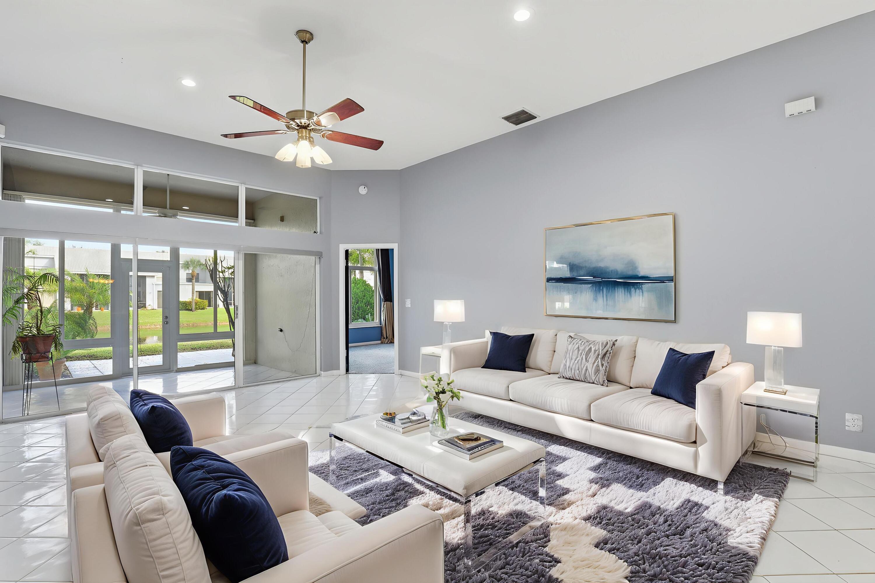 5405 Monterey Circle, Unit G Delray Beach, FL 33484 - Photo 28 of 72 a living room with furniture a chandelier and a large window