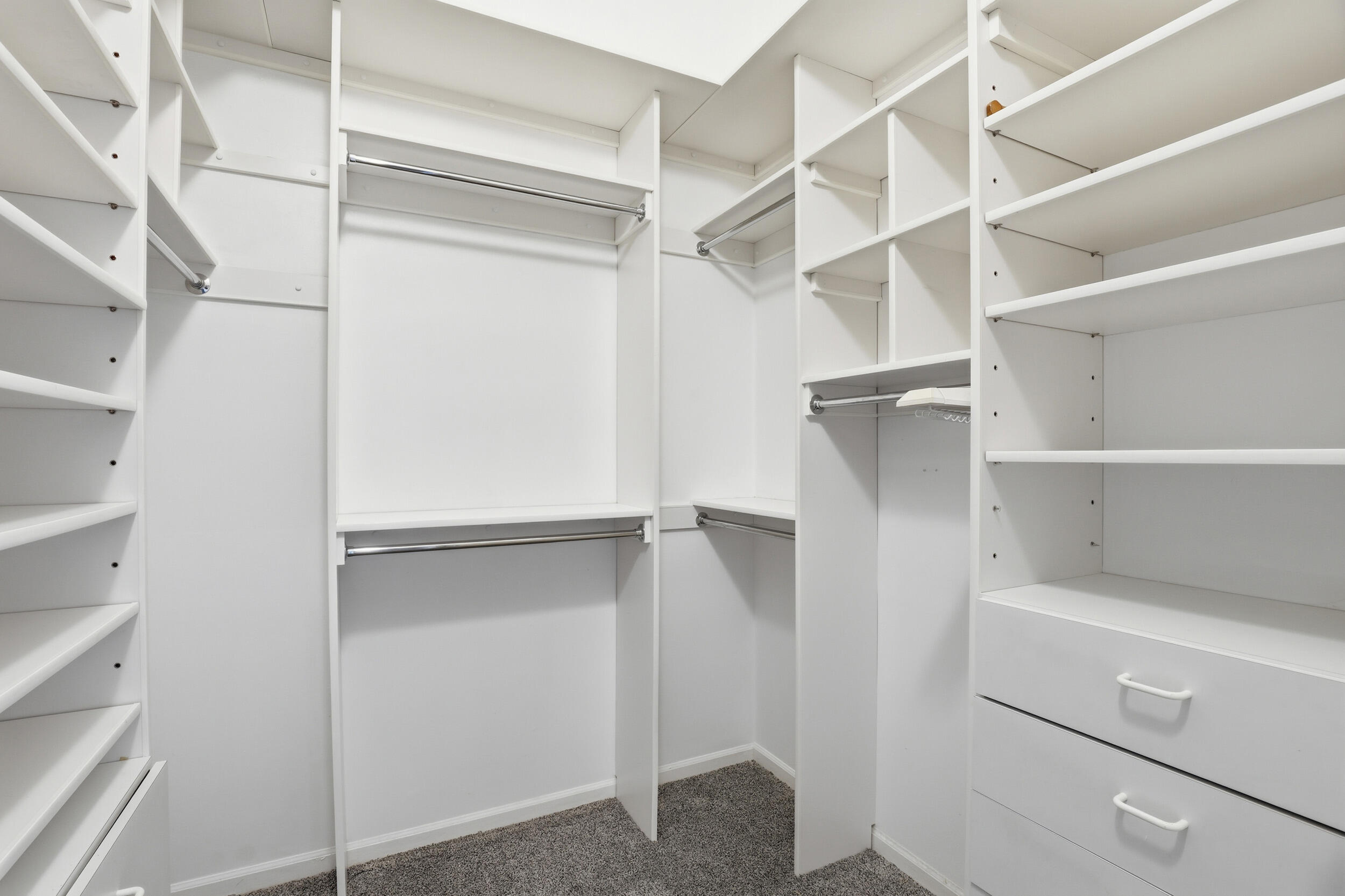 5405 Monterey Circle, Unit G Delray Beach, FL 33484 - Photo 39 of 72 a view of walk in closet with empty racks