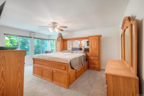 a spacious bedroom with a bed closet and a large window