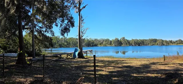 a view of a lake with houses in all around