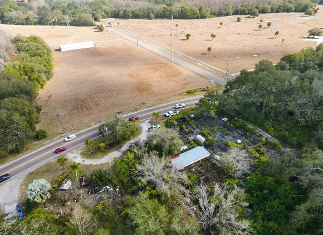 an aerial view of beach and residential houses with outdoor space