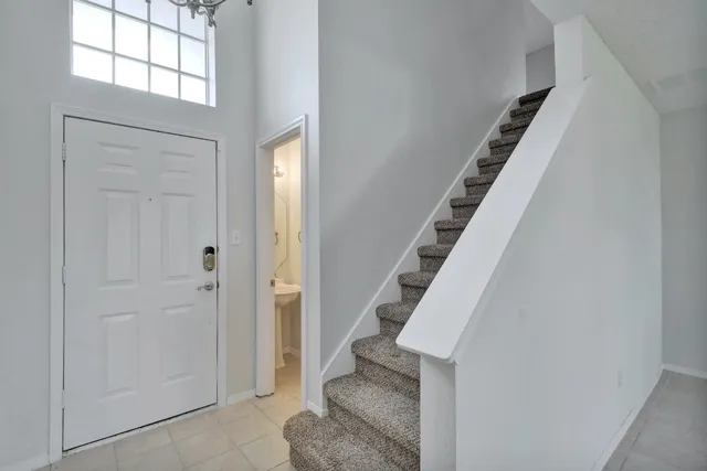 a view of entryway with wooden floor and stairs