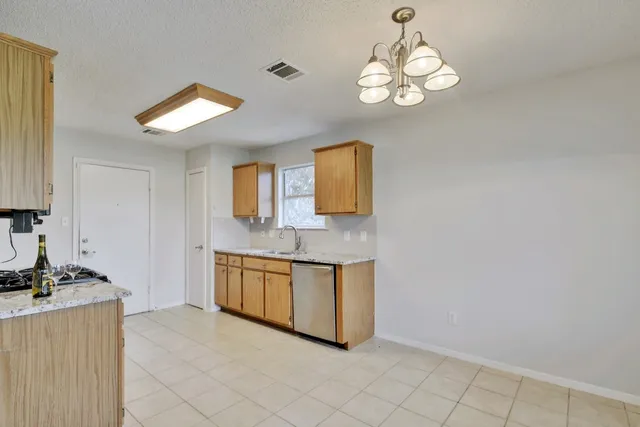 a spacious bathroom with a granite countertop sink and a mirror