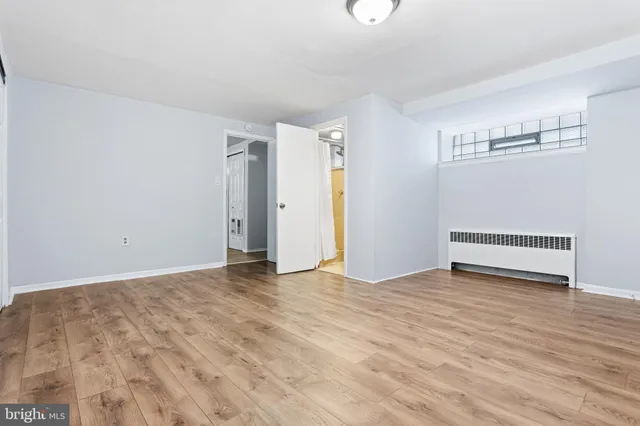 a view of an empty room with wooden floor