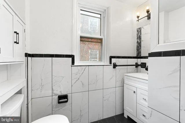 a bathroom with a sink a toilet and mirror