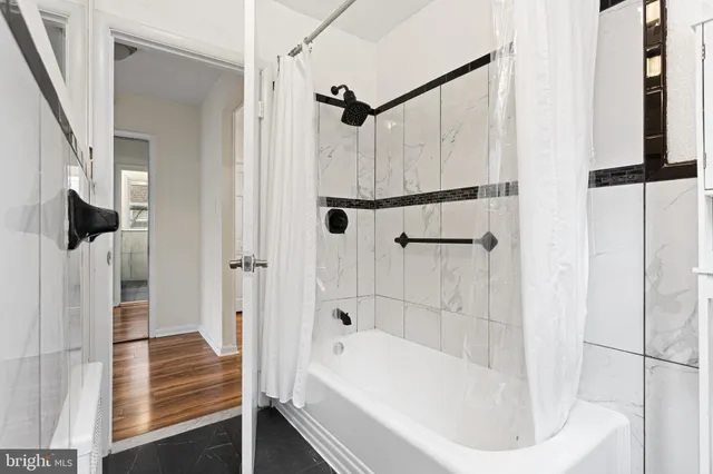 a bathroom with a bathtub and a shower