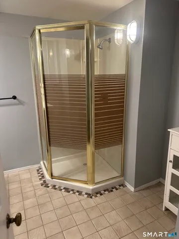 a bathroom with a glass shower door