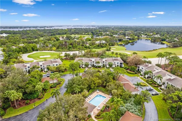 an aerial view of residential houses with outdoor space and swimming pool