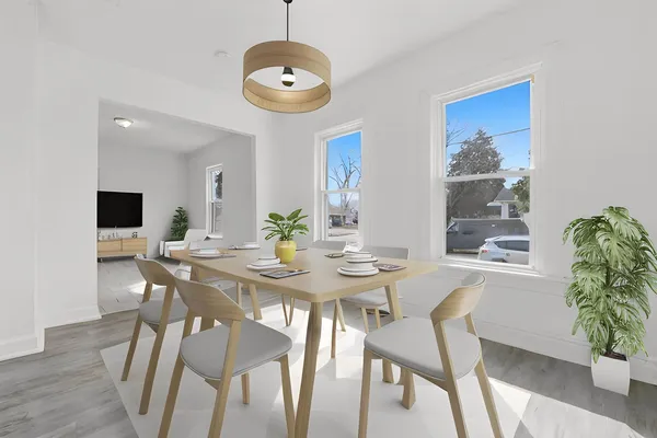 a view of a dining room with furniture and wooden floor