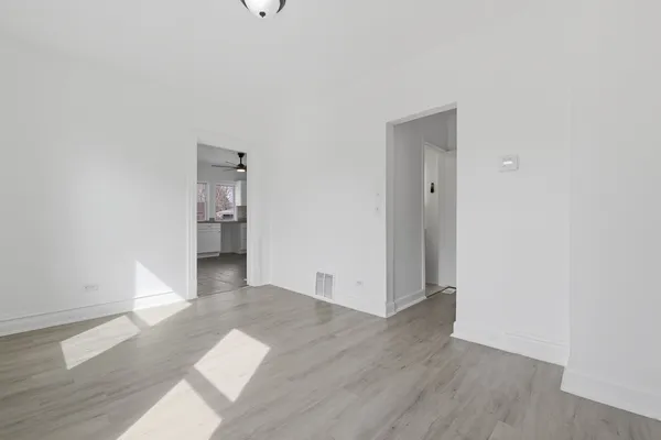 a view of a room with wooden floor and a sink