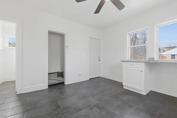 a view of room with ceiling fan and window