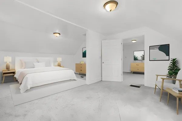 a spacious bedroom with a bed and a couch
