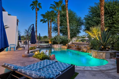 a view of a backyard with swimming pool