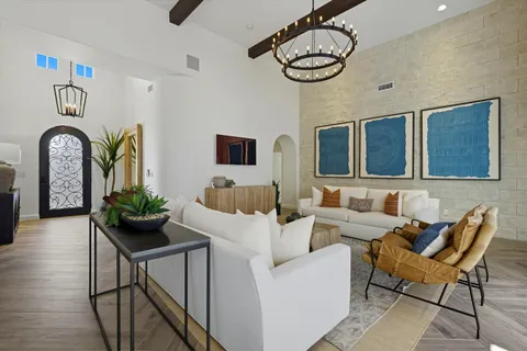 a kitchen with stainless steel appliances granite countertop a stove a sink dishwasher a microwave oven with white cabinets and wooden floor