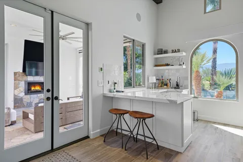 a living room with furniture and view of kitchen