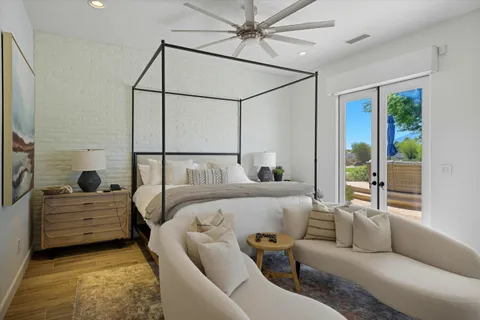 a living room with furniture a dining table and paintings on the wall