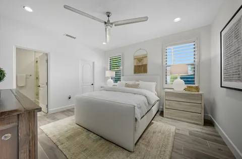 a bedroom with a bed and wooden floor