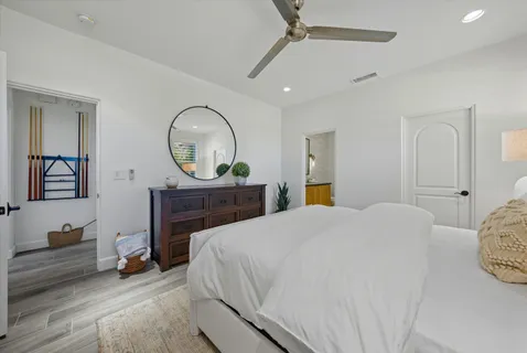 a bedroom with a bed and a chandelier