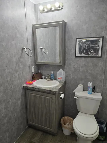 a picture of water heater room with wooden floor