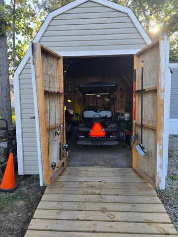 a kitchen with stainless steel appliances granite countertop a sink a stove and a wooden floor