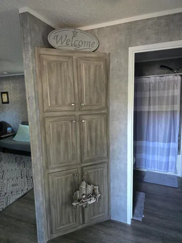 a kitchen with a stove and wooden floor