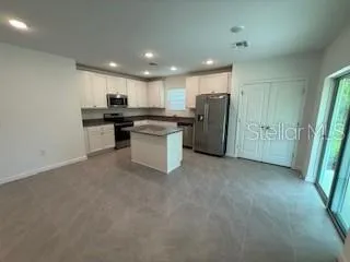 a kitchen with a refrigerator and a sink