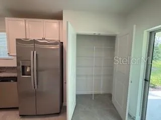 a kitchen with metallic refrigerator freezer and a dishwasher